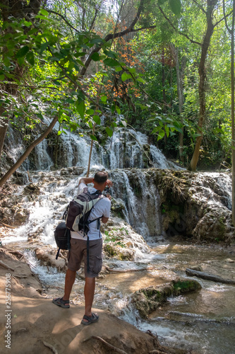 Undefined male person make photo of beautiful waterfalls at Krka National Park. Croatia
