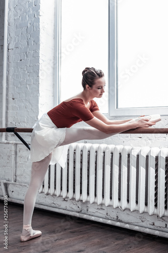 Attractive good looking woman training her flexibility