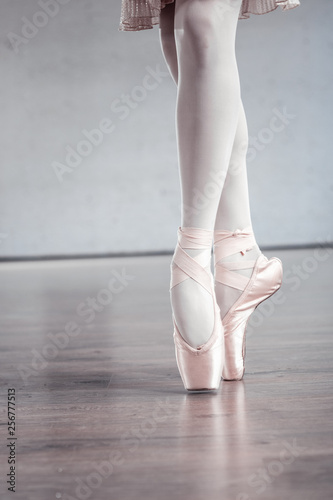 Attractive slim ballerina wearing special ballet shoes
