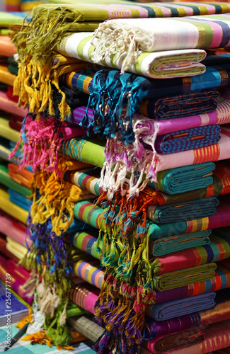  View of Indian woman dress sarees or saris stacked for display in a retail store