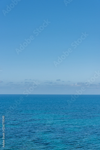 Clear Blue Sky Over the Turquoise Waters of the Southern Mediterranean Sea on the Italian Coast