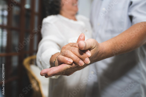 Meaningful moments. Lover senior couple dance together at home. Happy Anniversary cute family. Selective focus at hand.