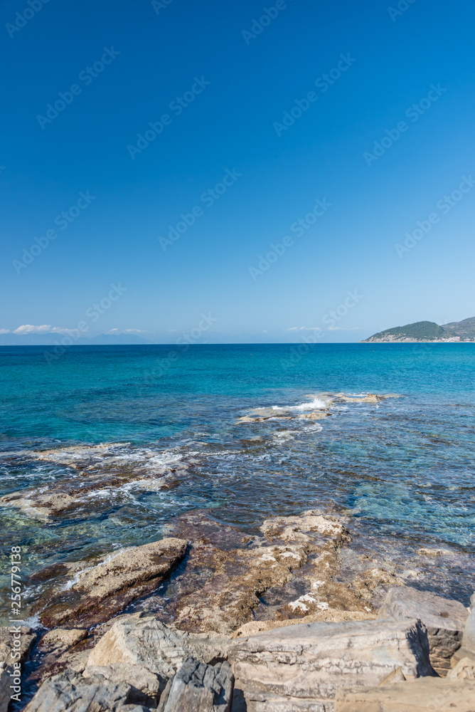 Waves on Rocks and the Clear Turquoise Blue Water at a Southern Mediterranean Beach in Italy Waves on Rocks and the Clear Turquoise Blue Water at a Southern Mediterranean Beach in Italy