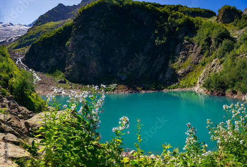 Alpine lake in the surroundings of Dombai. The Caucasus Mountains on a summer, clear day. Tourie Lake.