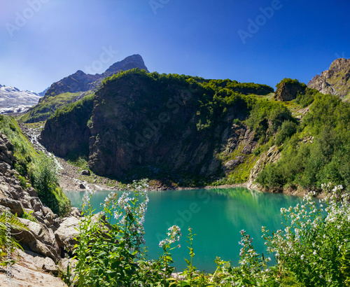 Alpine lake in the surroundings of Dombai. The Caucasus Mountains on a summer, clear day. Tourie Lake.