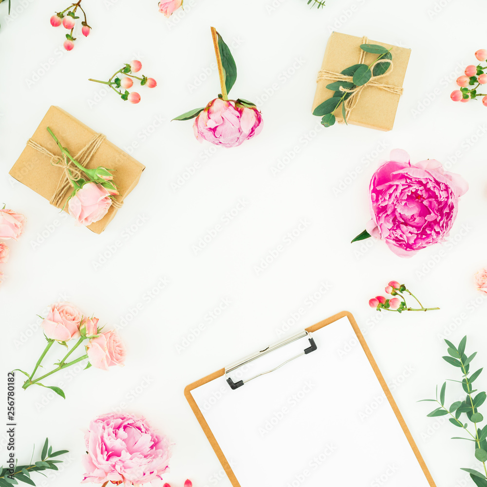 Obraz premium Floral frame of pink peonies, roses, hypericum and eucalyptus with clipboard and gifts on white background. Flat lay, top view