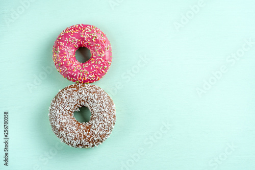Donuts on blue background, copy space.