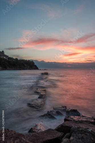 Long Exposure of a Sunset on the Southern Mediterranean Sea in Italy with Ancient Roman Wall © JonShore