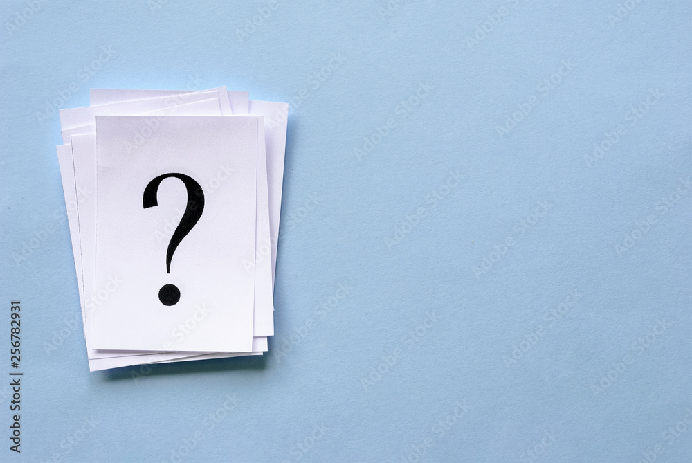 Pile of stacked question marks on white paper Pile of stacked question marks on white paper