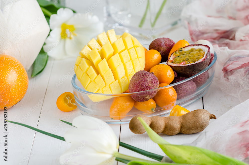 Exotic fruits and flowers on white wooden background. Exotic fruits and flowers on white wooden background.