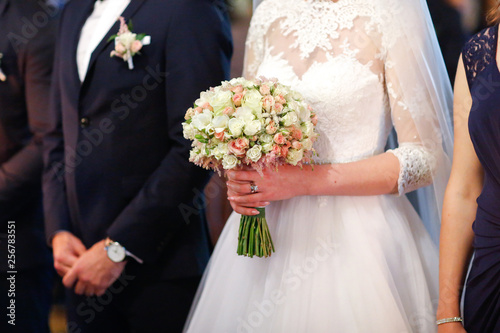 Beautiful bride holding bouquet of flowers