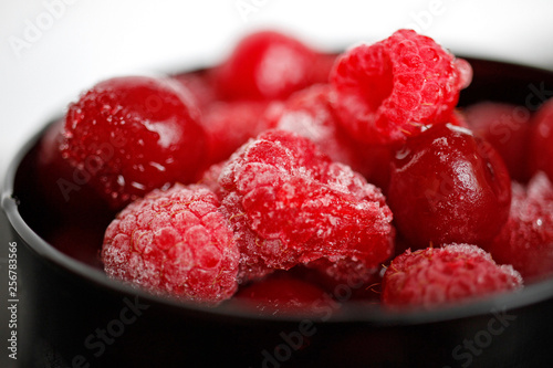 frozen raspberry berries in a black glass berry