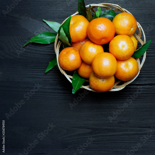 tangerines  in a basket on a black background fruit dessert healthy food
