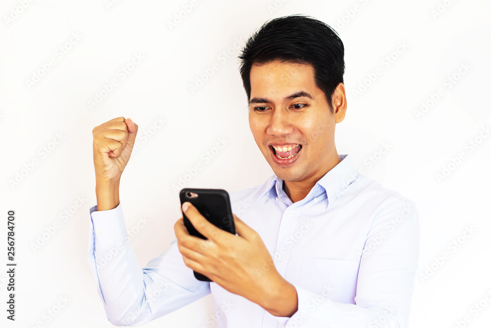 Asian business man get good news from smartphone Asian business man get good news from smartphone