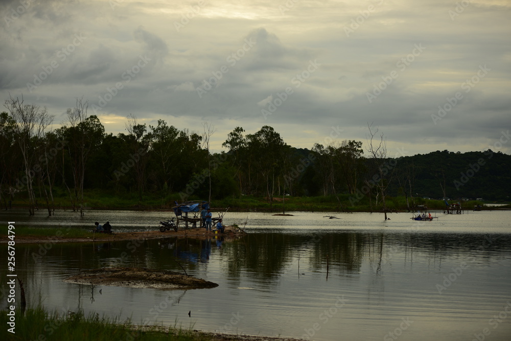 Nature view and Fishing people in the early hours of the dark Along the Bang Phra Reservoir
