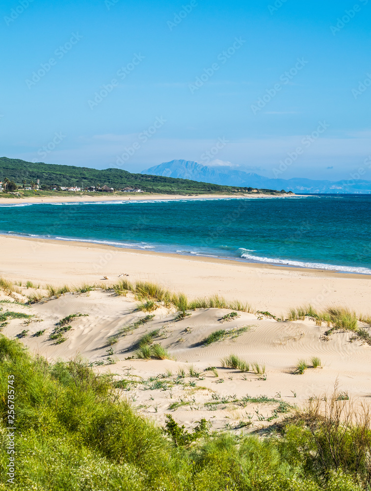 a tranquil beach scene in Bolonia, Spain with Africa in the background 