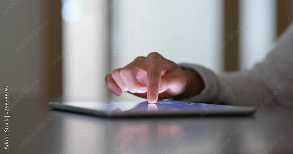 Woman finger touch on tablet computer at home Woman finger touch on tablet computer at home