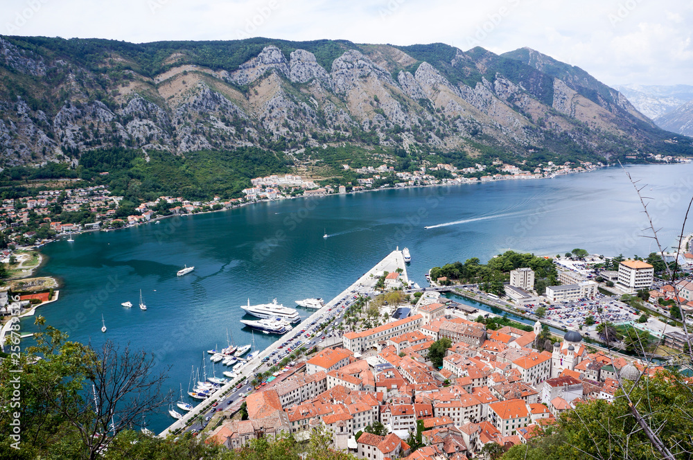 View from the top of hill on the old town Kotor and Kotor lake with moored yachts.