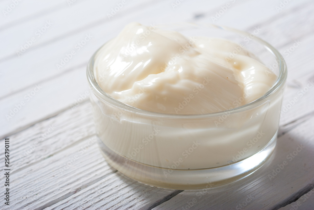 creme fraiche on white wood table background creme fraiche on white wood table background