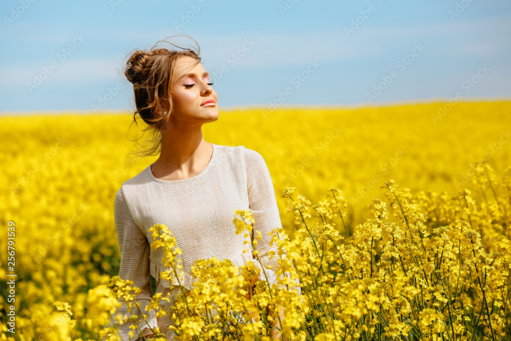 Beautiful blonde girl posing in yellow field Beautiful blonde girl posing in yellow field