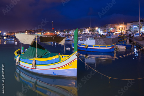 Traditional Maltese boats luzzu in Marsaxlokk at the night