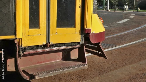 Traditional electric tram close the door and moves