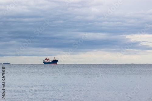 Tranquil seascape with ship at background