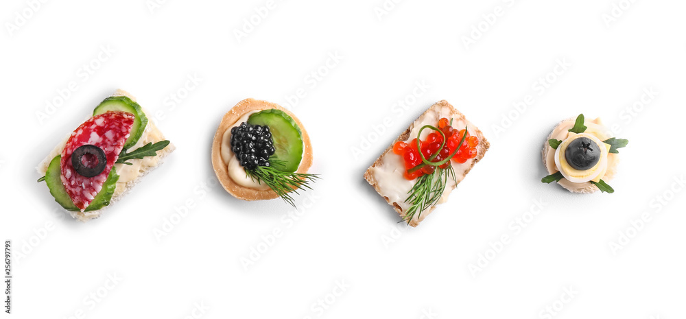Assortment of tasty canapes on white background
