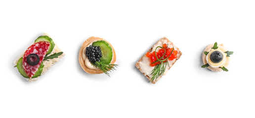 Assortment of tasty canapes on white background