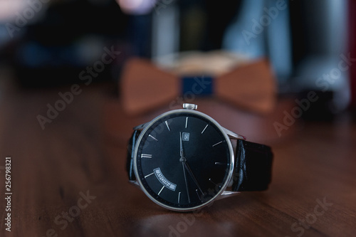 Men`s wrist watch with black leather strap closeup Very minimal
