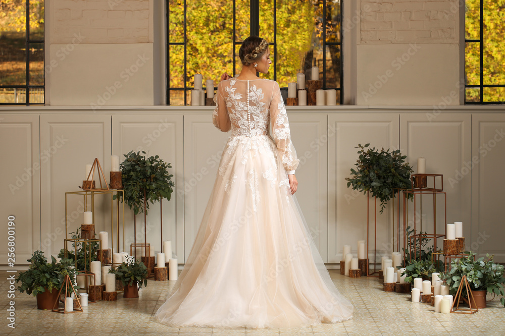 Fototapeta premium Beautiful blonde model posing in luxury wedding dress