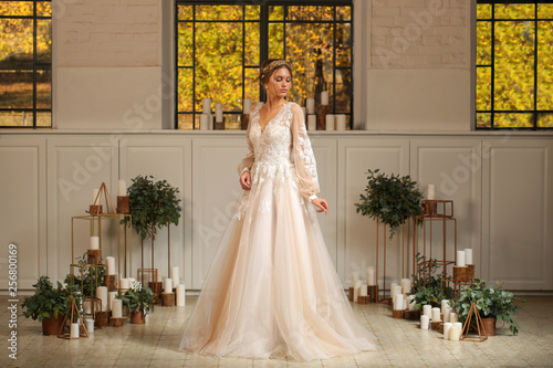Beautiful blonde model posing in luxury wedding dress