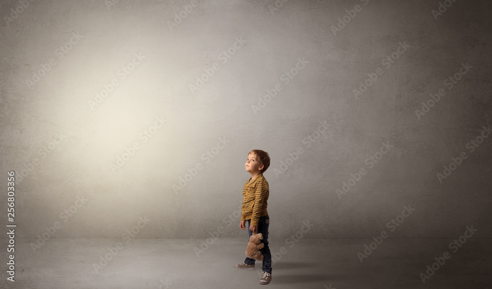 Little waggish kid staying alone in a big empty room with his plush
Little waggish kid staying alone in a big empty room with his plush