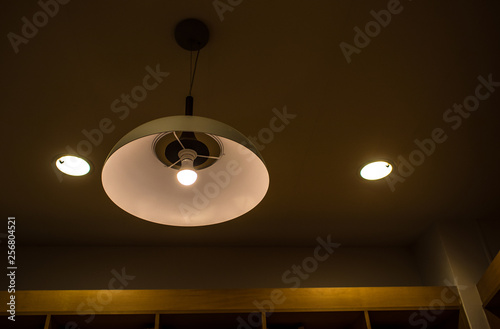 Konstfotografi Lighting fixture lamps are hanging on textile classic cable from the ceiling