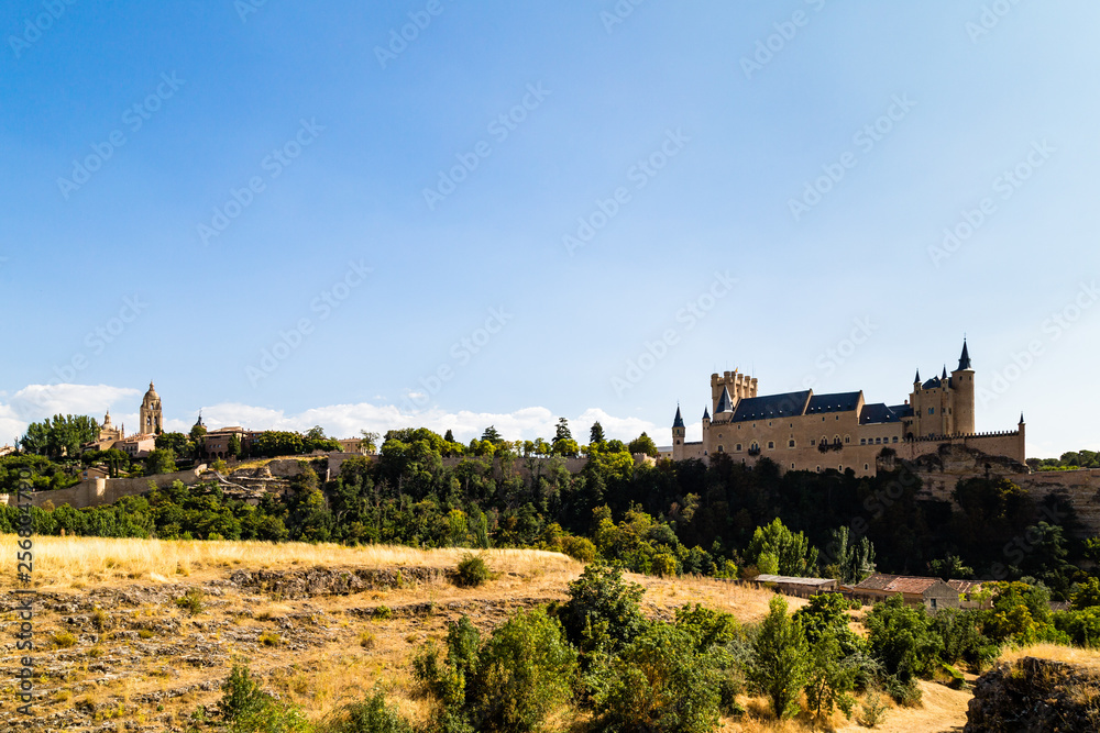 View of Segovia Old Town in Summer from the field next to Iglesia de la Vera Cruz, an ancient Templar church. Castilla Y Leon, Spain. Cathedral and Alcazar are visible in the picture