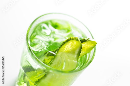 Refreshing non-alcoholic summer cocktail with cucumber close up soft focus on a white background