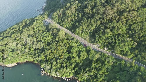 Drone view distancing showing cars passing by the jungle mountain from Interpraias road at Balneario Camboriu, Santa Catarina, Brazil photo