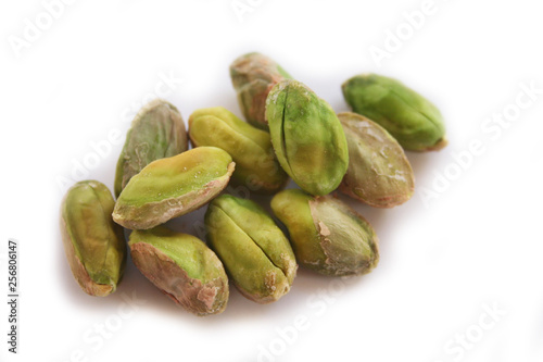 Shelled pistachios isolated on white background in selective focus