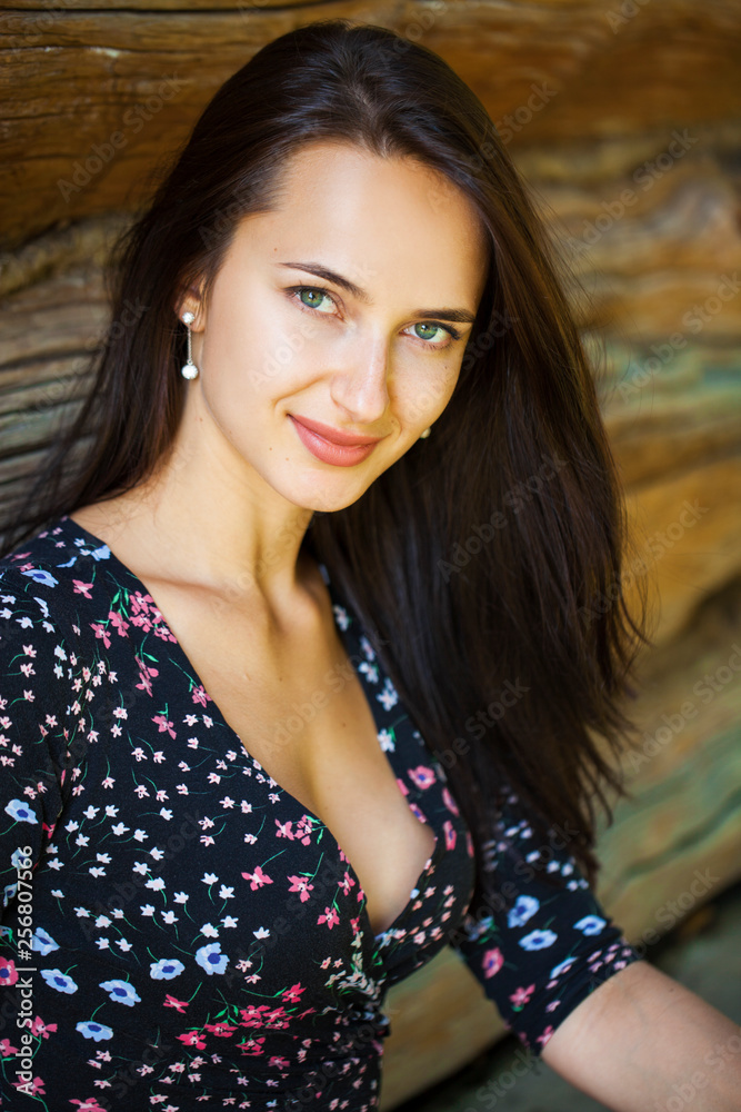 Fototapeta premium Young brunette woman in summer park