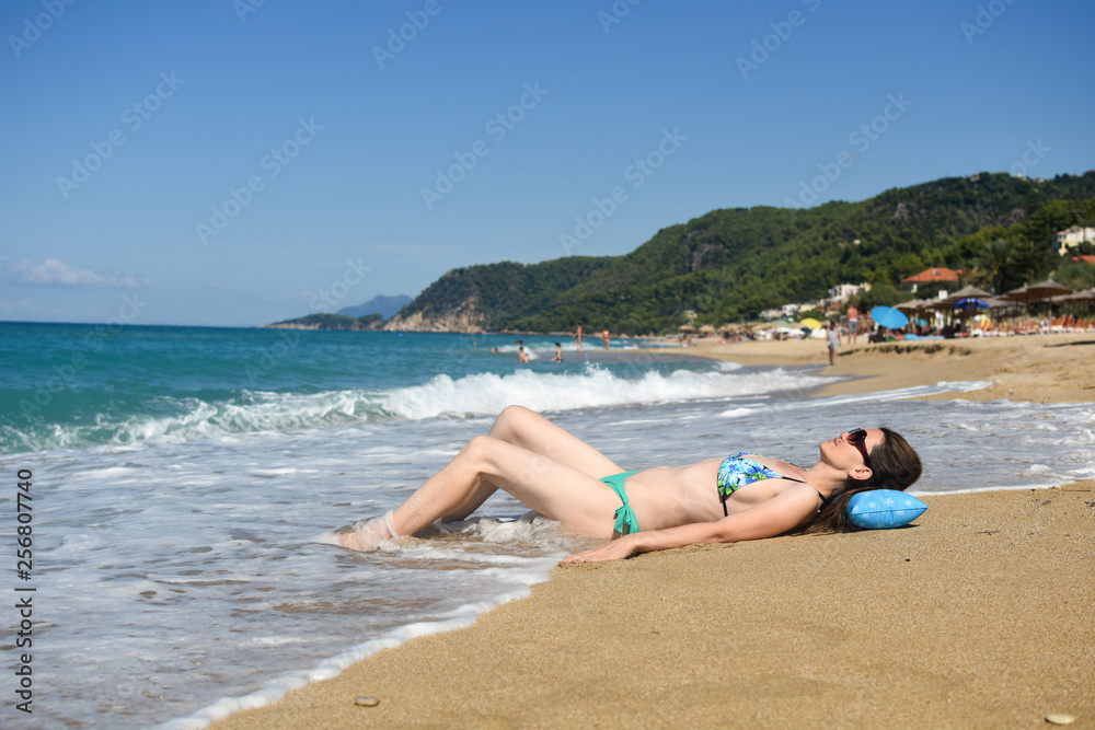 Woman lies and enjoy at beach. Summer vacations concept, sexy woman on tropical beach Woman lies and enjoy at beach. Summer vacations concept, sexy woman on tropical beach