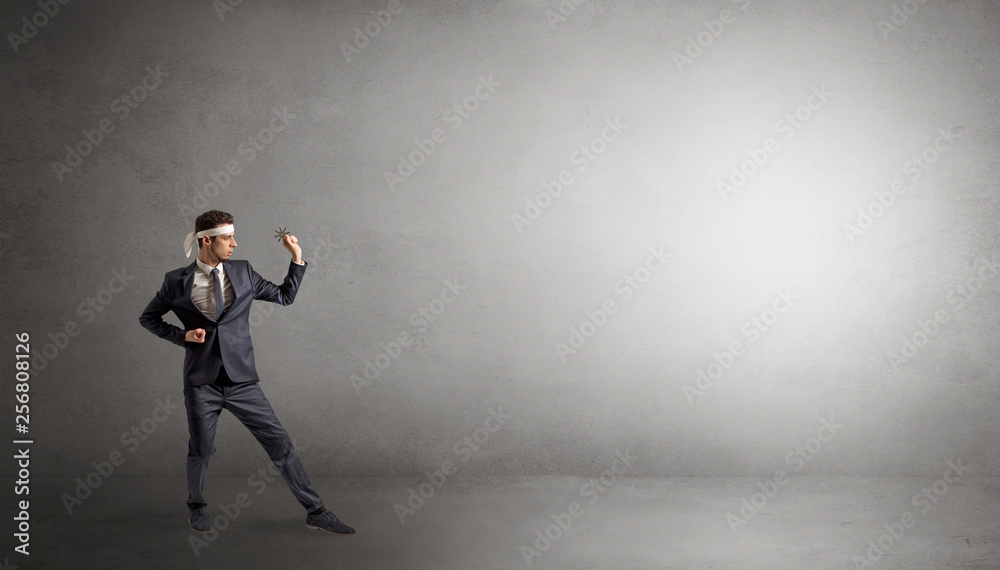 Small karate man fighting in an empty grey copy space Small karate man fighting in an empty grey copy space