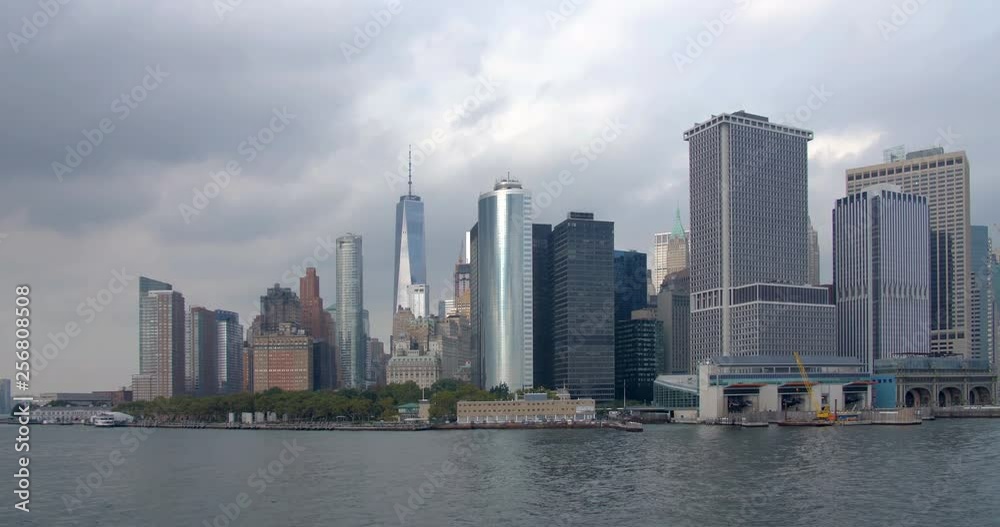 Moving view from water of Lower Manhattan skyline and Battery Park, New York City on an overcast day. Moving view from water of Lower Manhattan skyline and Battery Park, New York City on an overcast day.