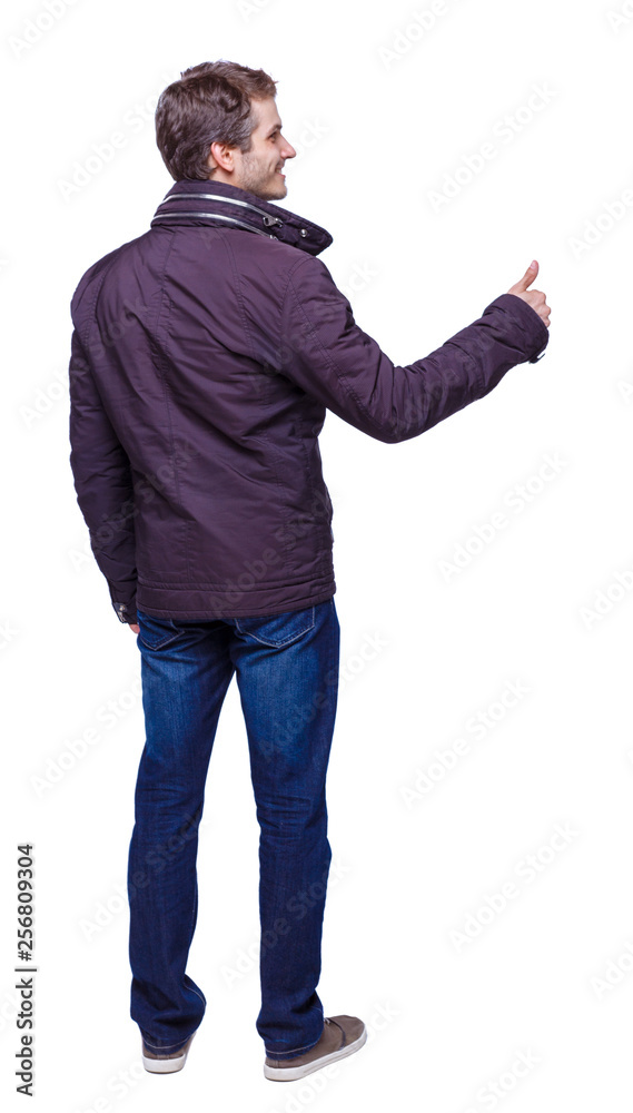 Back view of man in parka thumbs up. Back view of man in parka thumbs up.