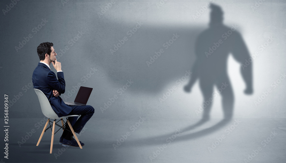 Humble businessman staying and offering stuffs to a superhero shadow
Humble businessman staying and offering stuffs to a superhero shadow