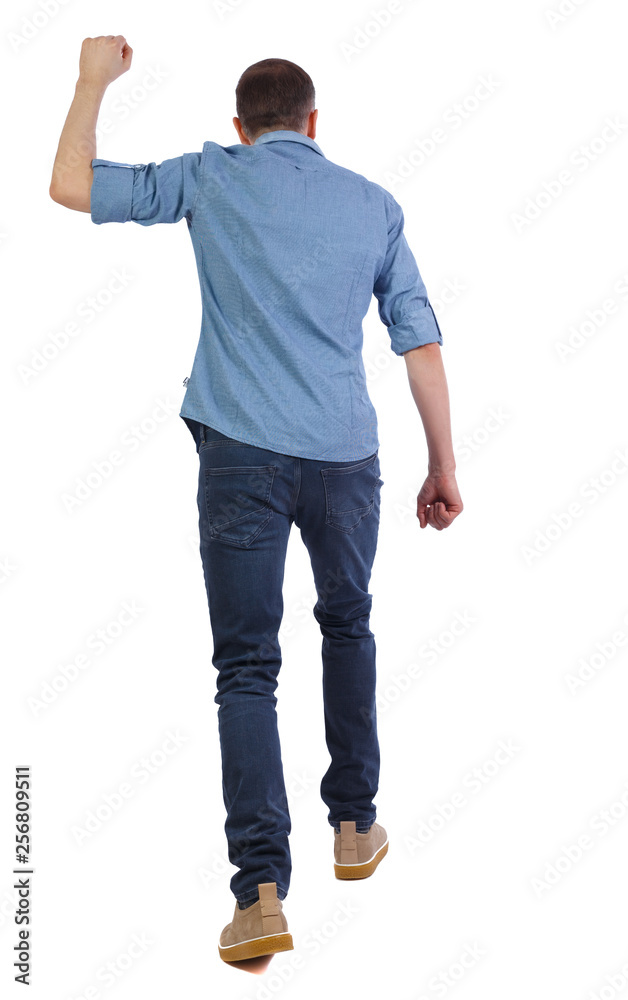 Back view of a man who goes and swings his fist. Back view of a man who goes and swings his fist.