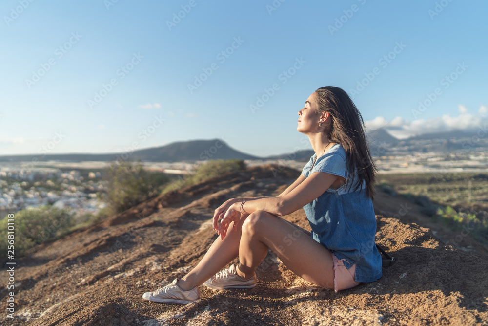 Pretty tourist brunette girl relaxing near mountains. Pretty tourist brunette girl relaxing near mountains.