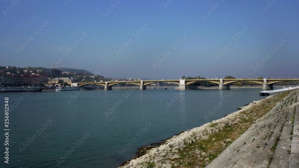Cars driving across a bridge over the Danube River on a sunny day. Cars driving across a bridge over the Danube River on a sunny day.