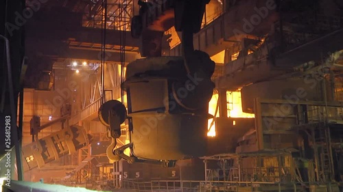 The process of pouring iron into the converter. Steel production at a metallurgical plant.