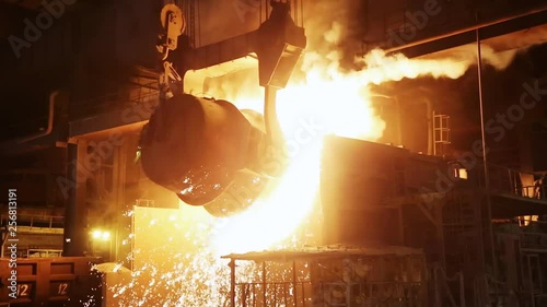 The process of pouring iron into the converter. Steel production at a metallurgical plant.