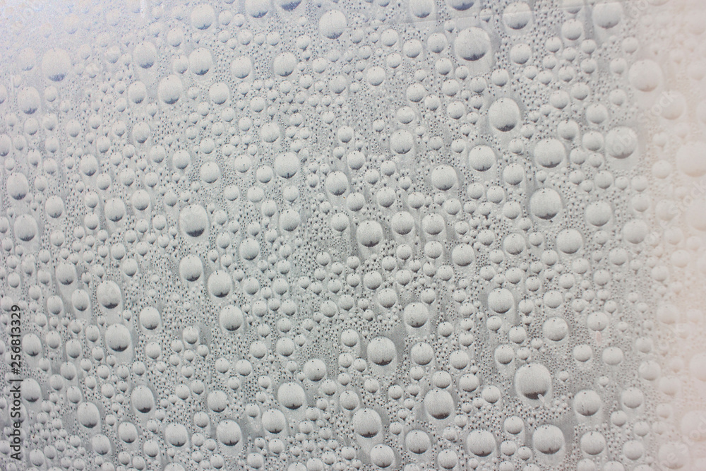 Big drops of water on the glass. Wet surface. Liquid.